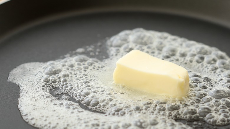 butter melting and bubbling in frying pan