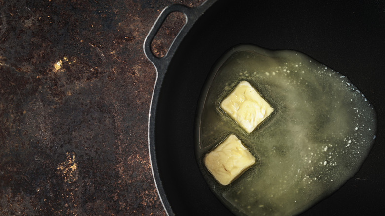 Butter melting in hot cast iron pan