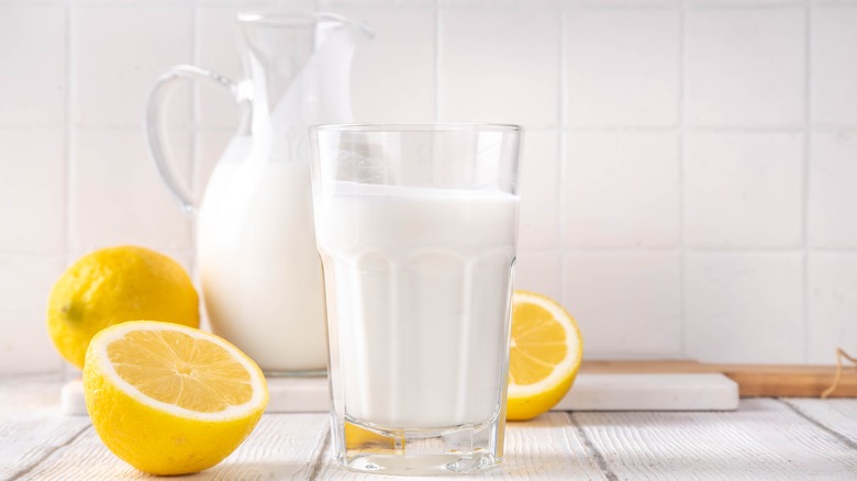 Pitcher and glass of milk with lemons