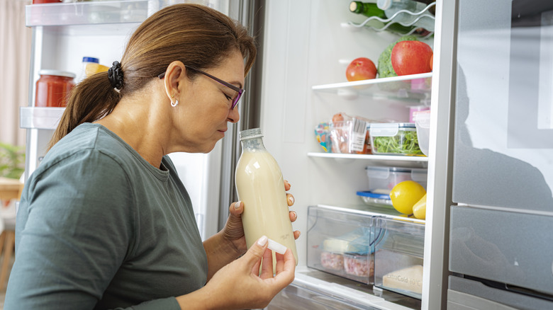 Person sniffing milk