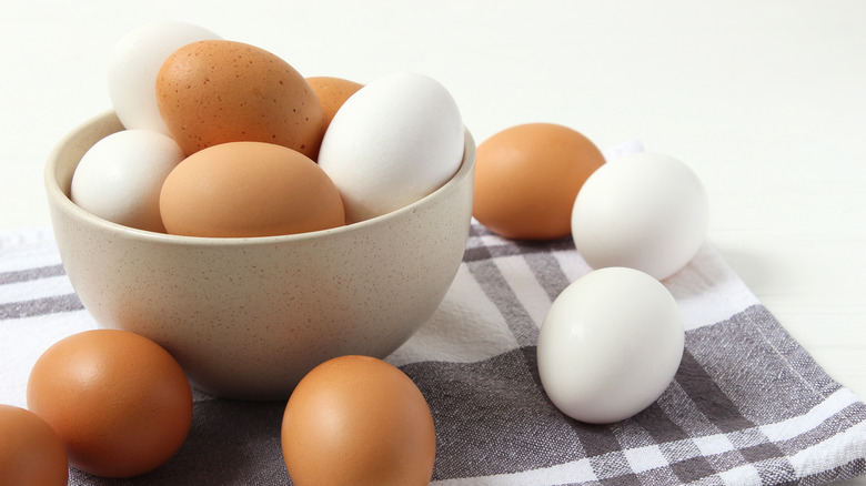 Brown and white eggs in a bowl