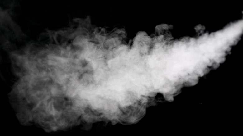 spray of steam on black background