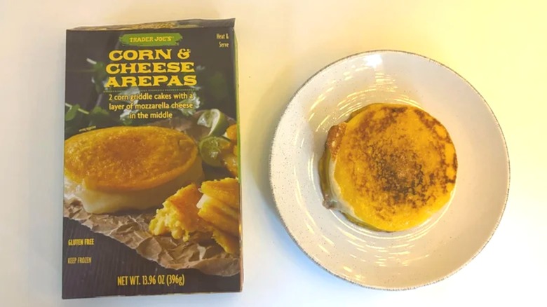 Box of Trader Joe's Corn & Cheese Arepas next to arepas on white plate