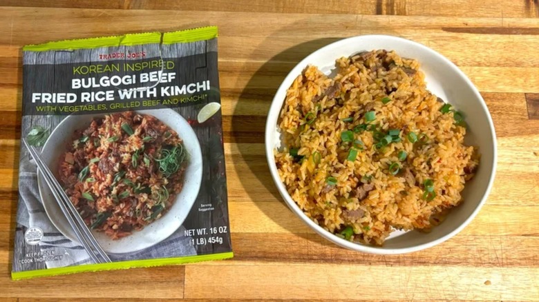 Trader Joe's Bulgogi Beef Fried Rice with Kimchi bag on table next to white bowl of bulgogi