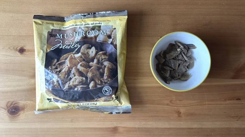 Bag of Trader Joe's Mushroom Medley next to mushroom medley in bowl on wooden surface