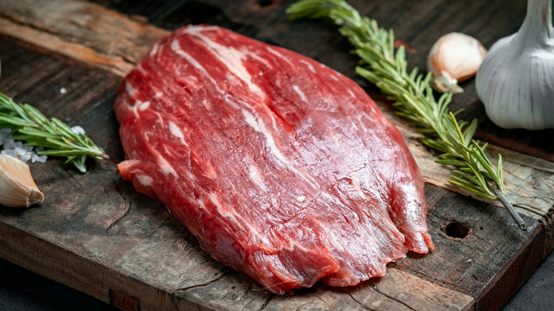 Raw flank steak cutting board