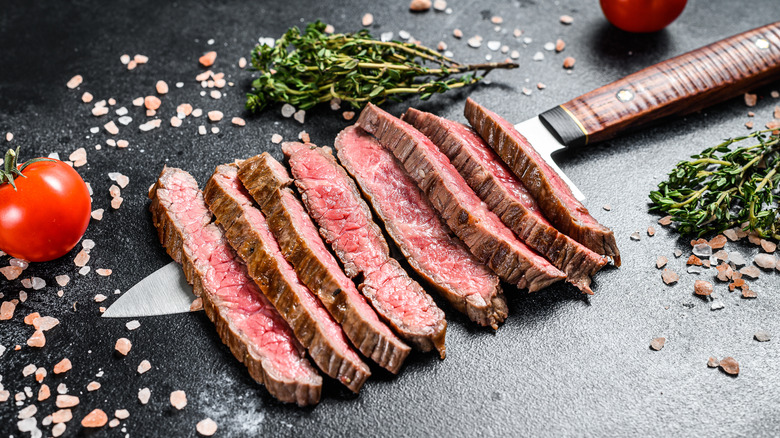 Sliced flat iron steak on knife