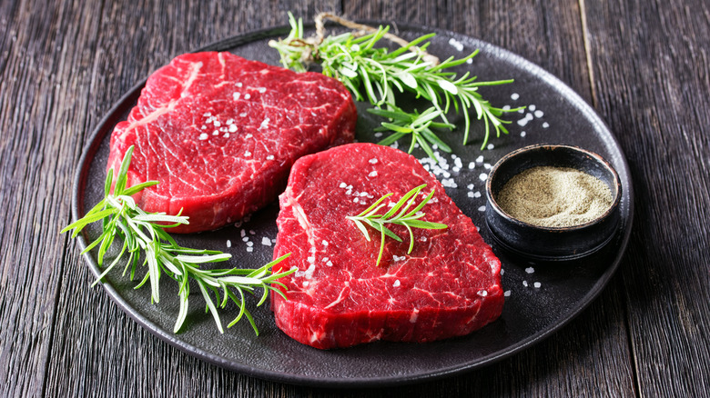 Two raw sirloin tip steaks