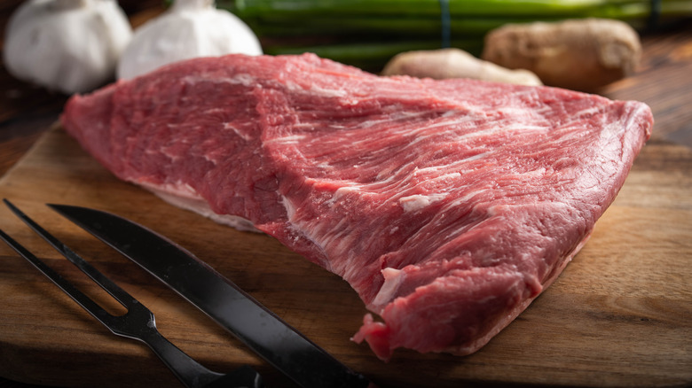 Tri-tip steak raw cutting board