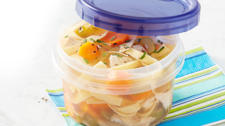 Chicken noodle soup with carrots in container