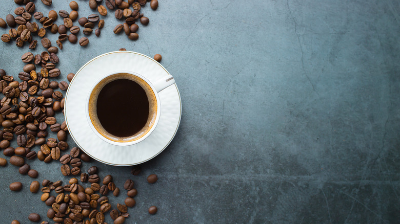 Cup of coffee with beans