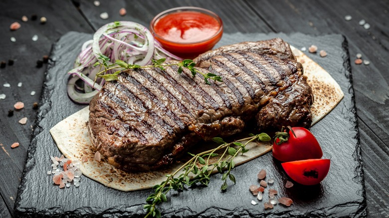 Strip steak resting on board