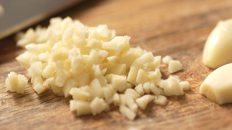 Freshly minced garlic on cutting board