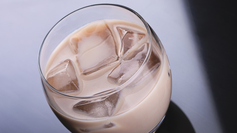 Irish cream in clear glass with ice cubes