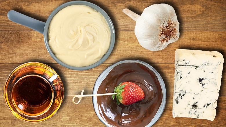 pot of fondue surrounded by various ingredients