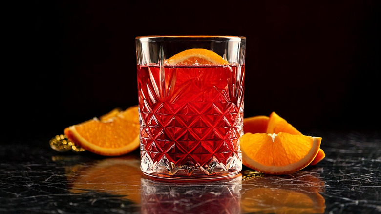 Negroni with vermouth on black background