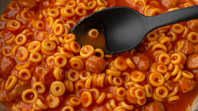 Spaghettios with black spoon.