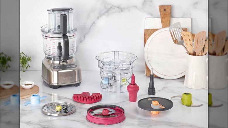 Breville the Paradice food processor on countertop with all of its accessories