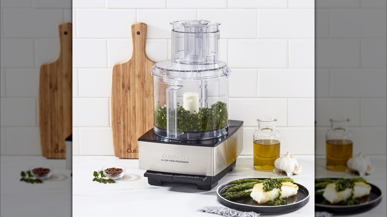 Cuisinart Custom Food Processor on a kitchen counter next to grilled fish with asparagus