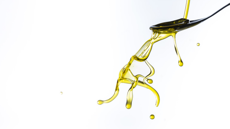 olive oil drizzling onto spoon