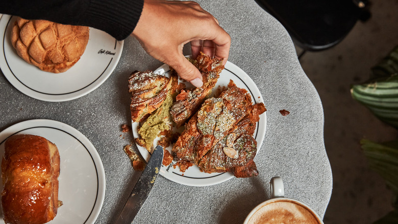 Pistachio croissant cut open flatlay