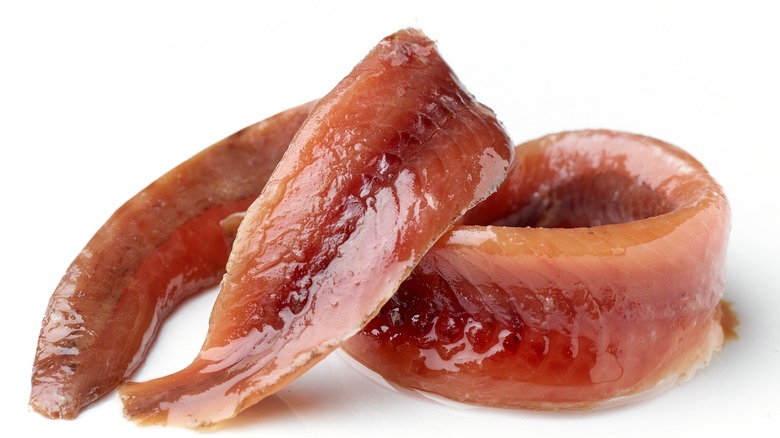 Anchovy filets on white background 