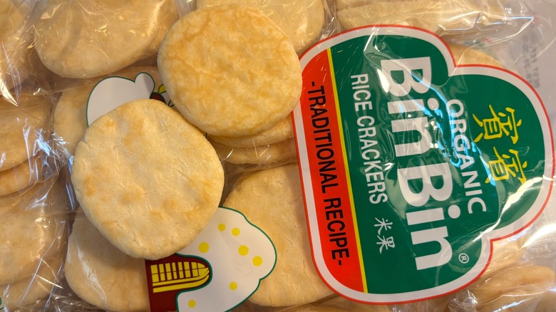 Two crackers on top of package of Bin Bin rice crackers