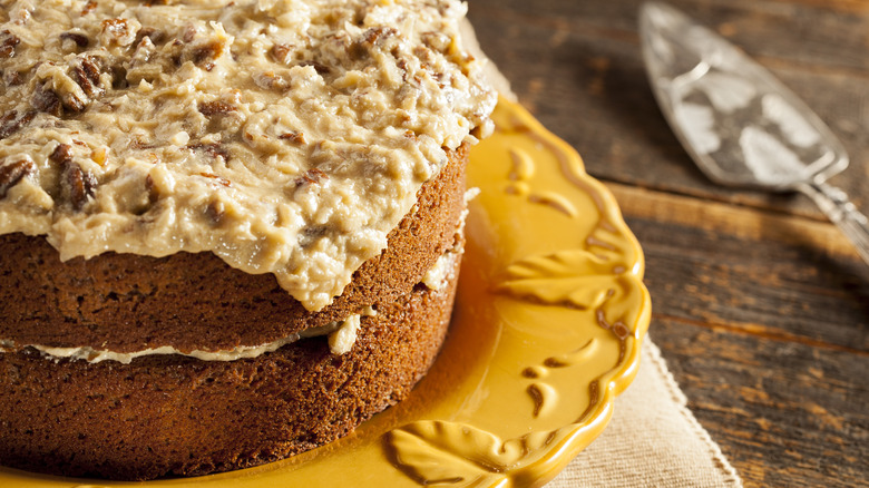 German chocolate cake on yellow platter