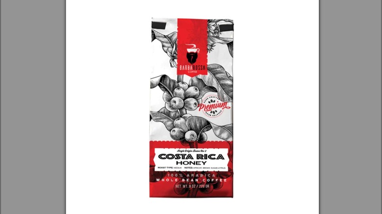 Red and white bag of Barbarossa brand Costa Rican honey coffee on solid white background