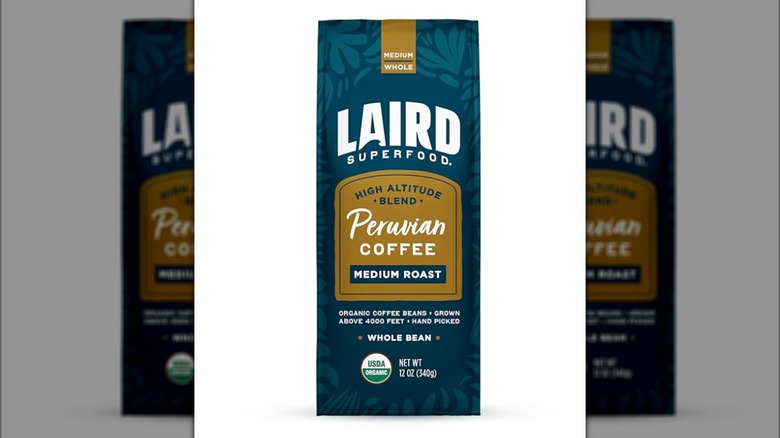 Blue bag of Laird Superfood brand Peruvian coffee isolated on white background