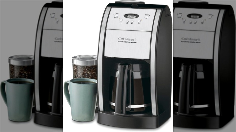 Cuisinart DGB-550BKP1 Automatic Coffeemaker Grind & Brew 12-Cup appliance with mug and coffee beans is on display.