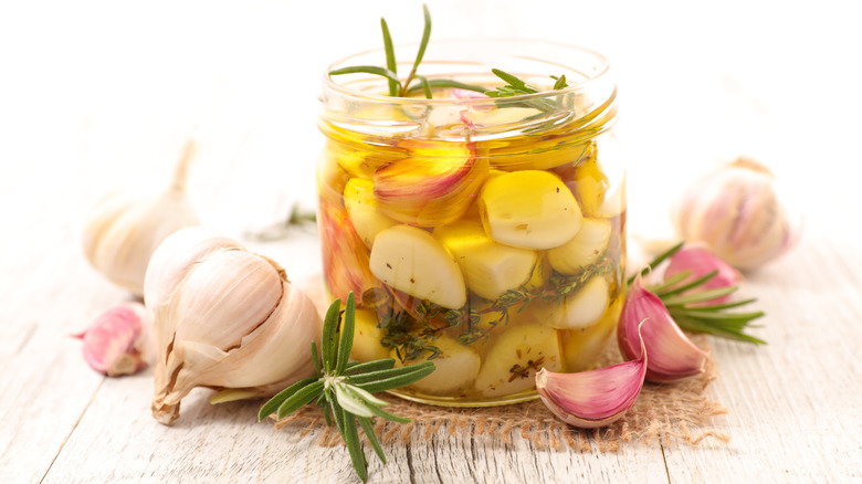 Garlic cloves and oil in jar