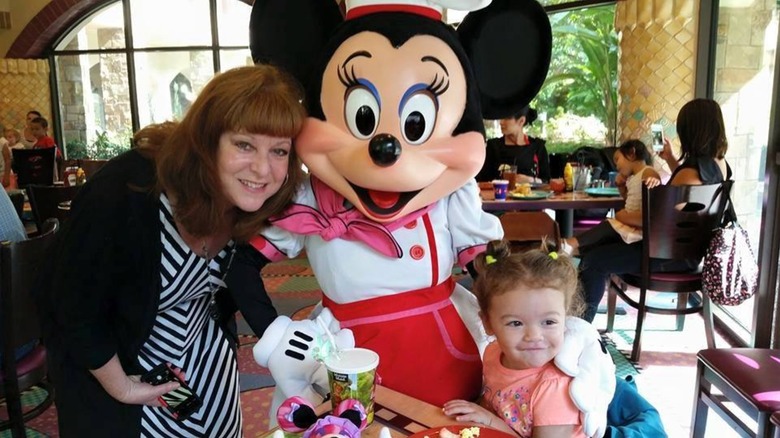 toddler and adult with Minnie Mouse in Goofy's Kitchen