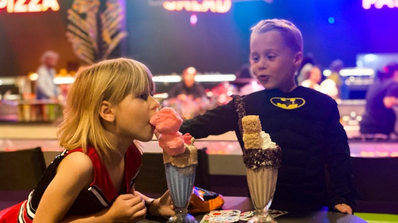 Kids enjoying treats from Jake's Unlimited near the buffet