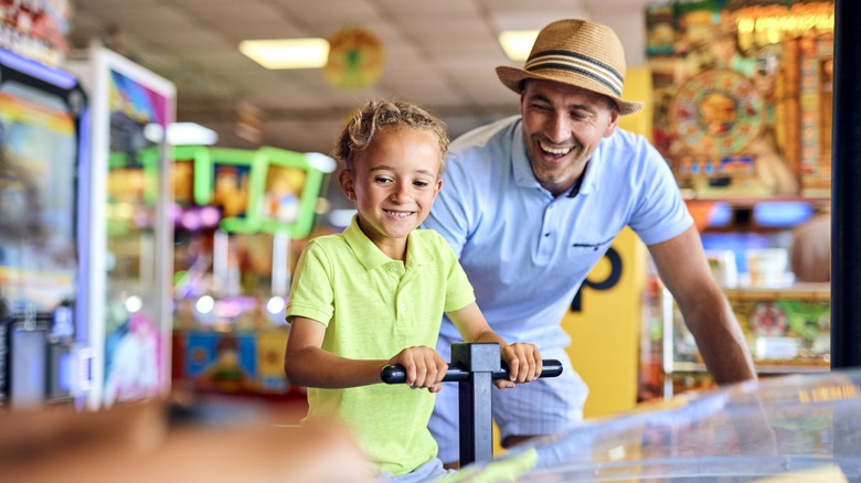 adult with child in arcade