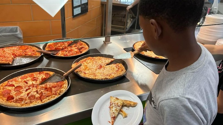 boy getting pizza from the Mr. Gatti's Pizza buffet