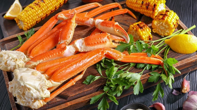 Crab House crab legs and grilled corn on a wooden board