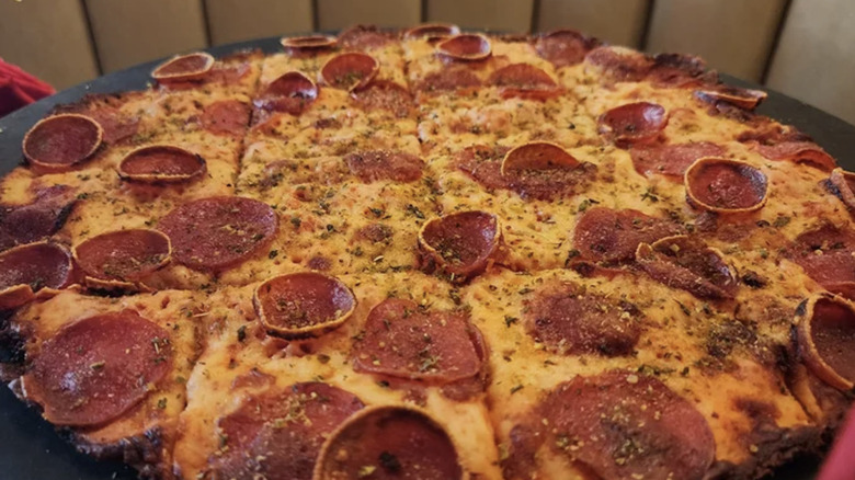 Pizza Hut square cut thin crust pizza covered in pepperoni.