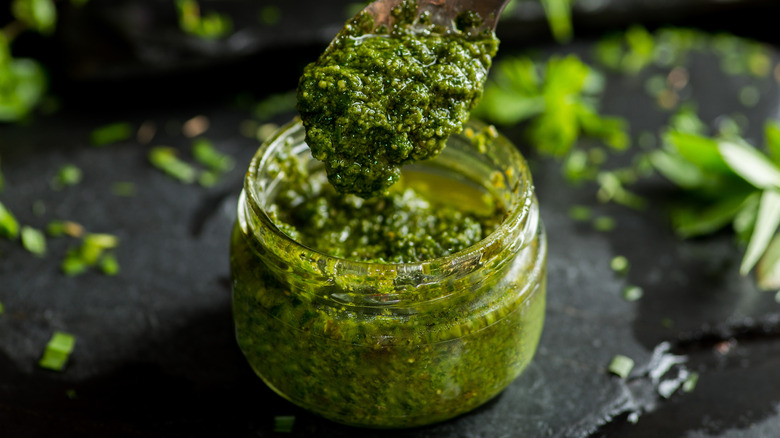 Green pesto jar and spoon