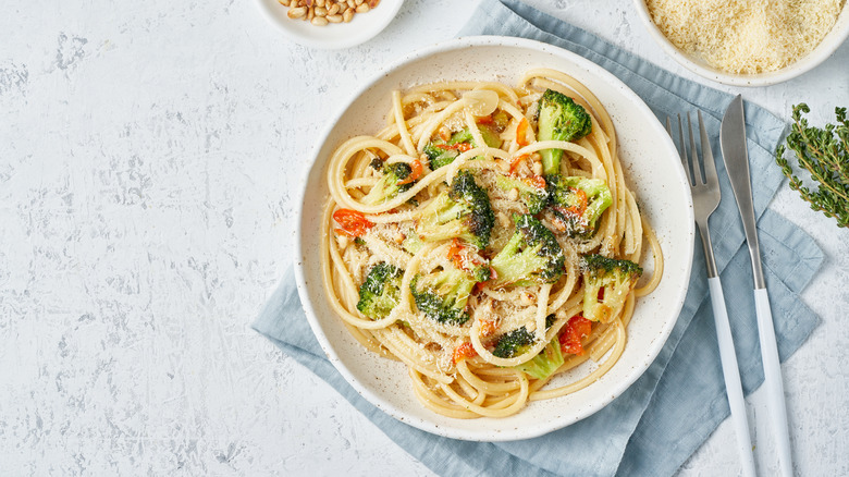 bucatini pasta with broccoli, peppers, garlic, pine nuts