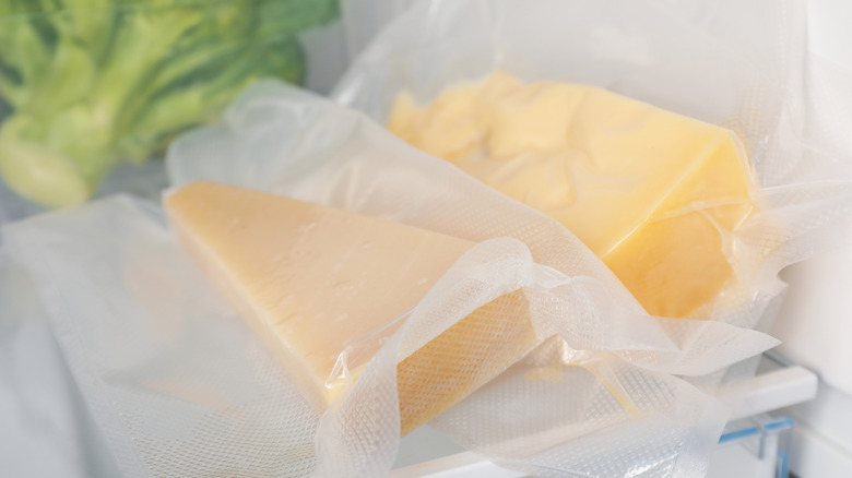 Wrapped wedges of cheese in refrigerator