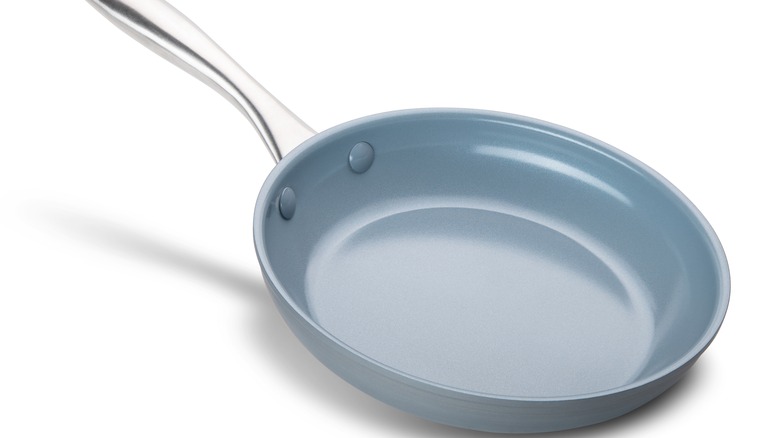 Blue nonstick pan on white background 
