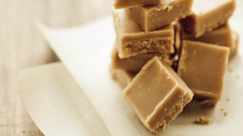 Stacked caramels on white paper 