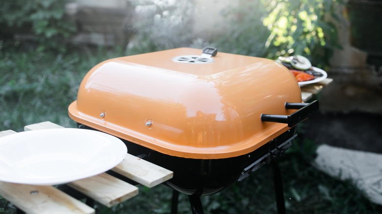 Closed grill with an orange lid