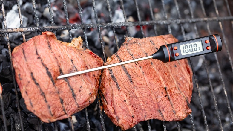 steaks being tested with a meat thermometer