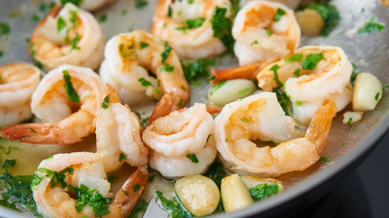 cooked shrimp herbs garlic pan 