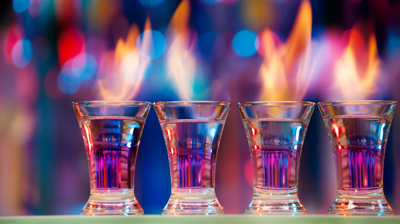 Four flaming shots of alcohol