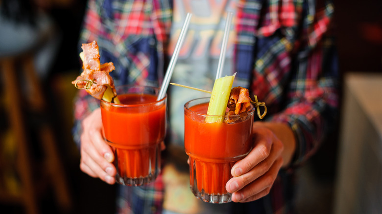 Man holding Bloody Mary drinks