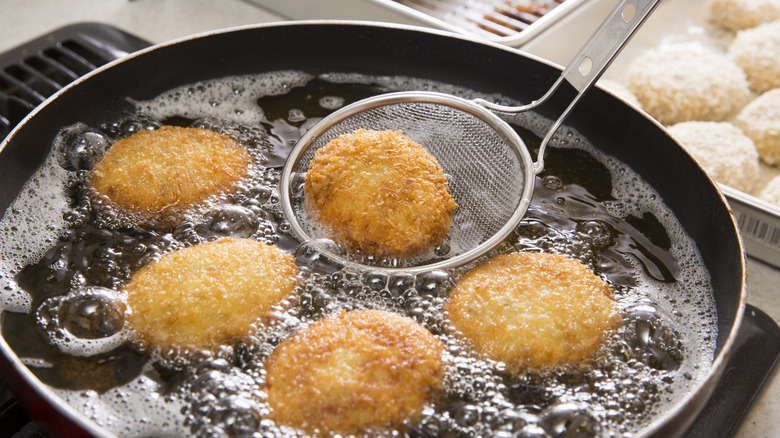 croquettes frying in pan