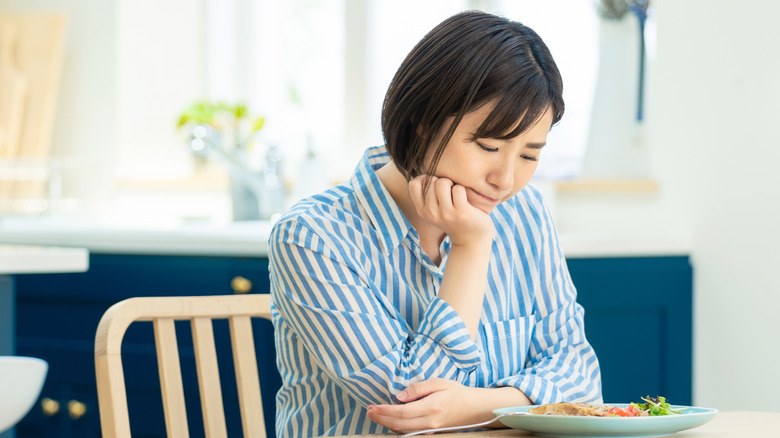 Woman stressed with her meal